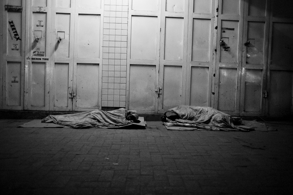 Street children sleep by a